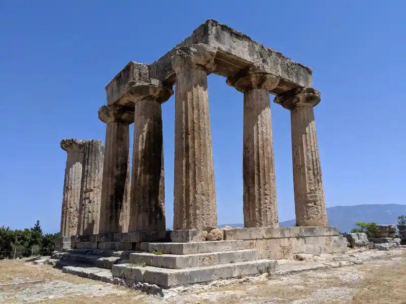 Seven standing columns and upper stone blocks of a temple of Apollo at ancient Corinth, Greece